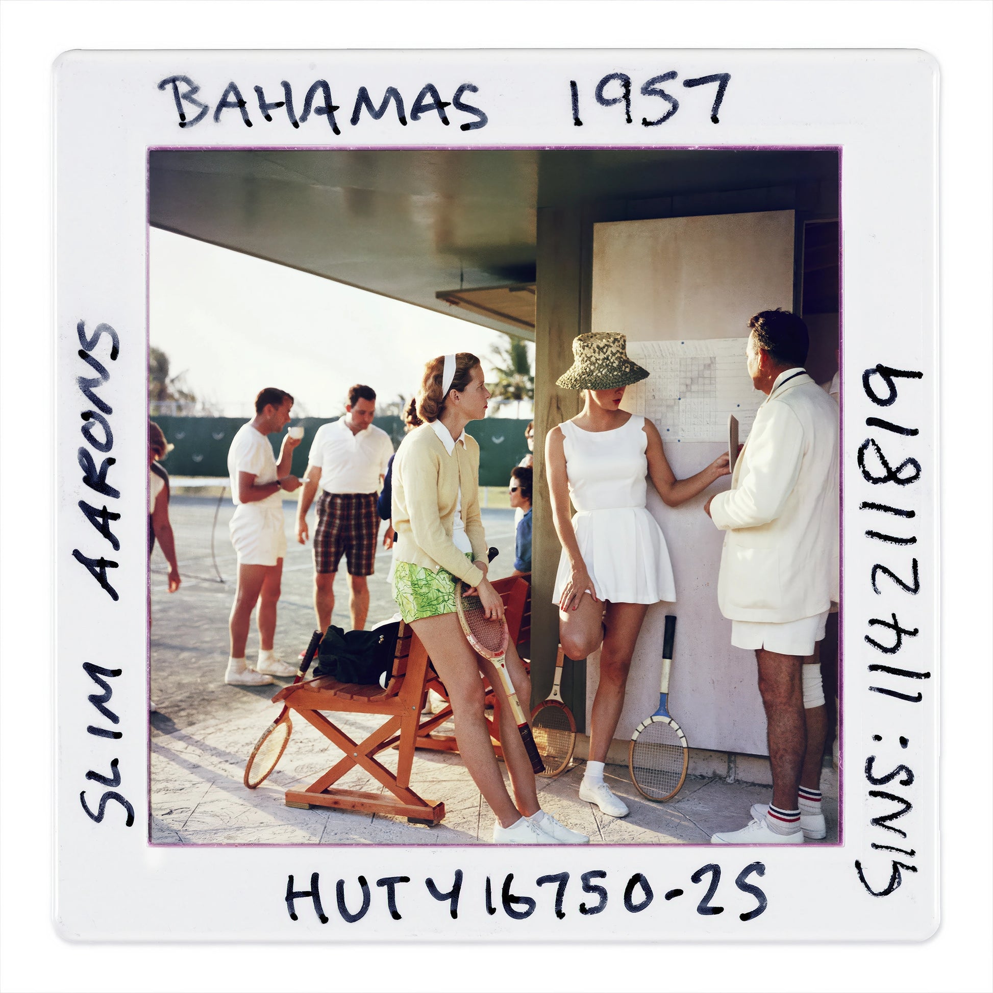 Vintage photo of people in Bahama attire with text 'Bahamas 1957' on a white border.