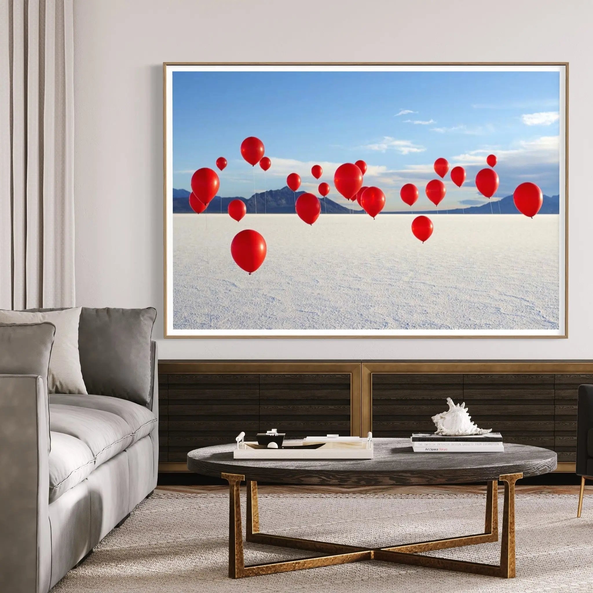 Red Balloons on Salt Flats by Andy Ryan displayed in a modern living room interior