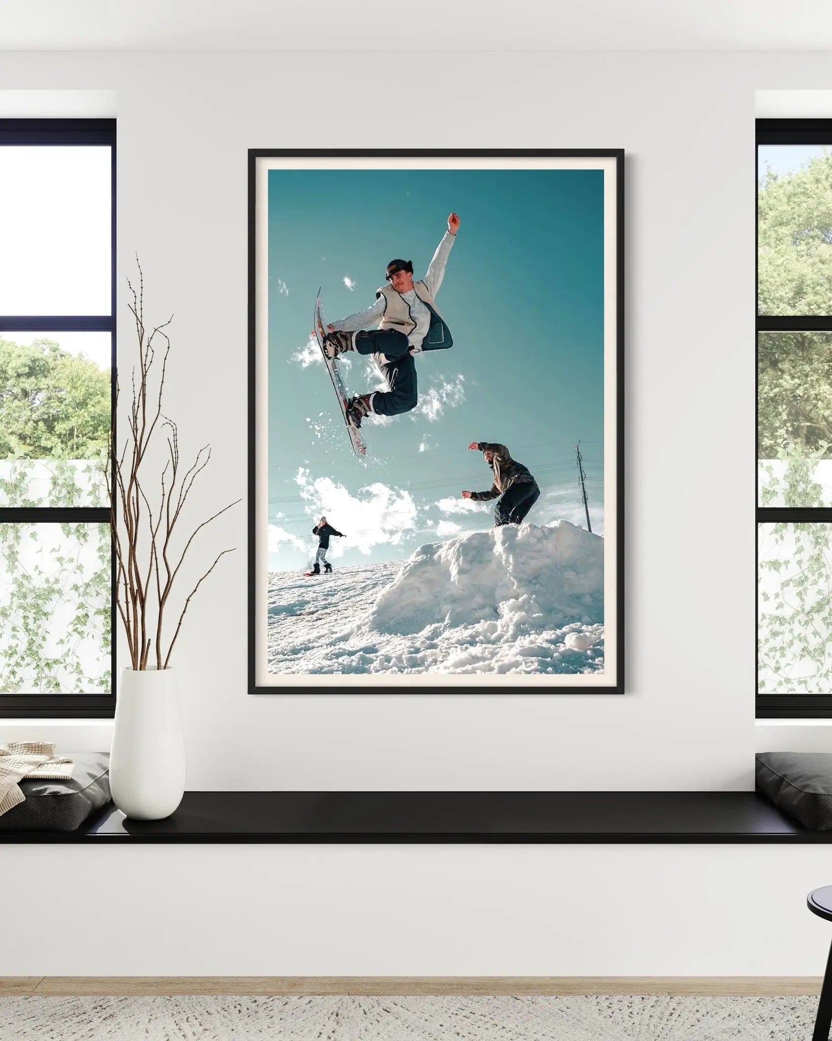 Snowboarders by C. Lloyd displayed in a modern living room interior