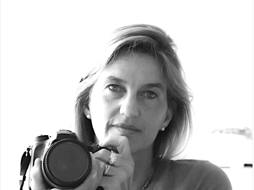 Black and white photo of a woman holding a camera