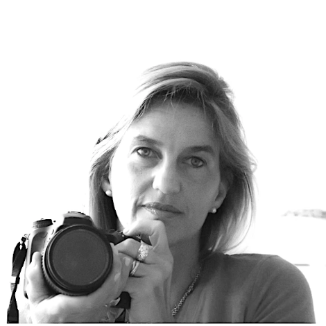 Black and white photo of a woman holding a camera