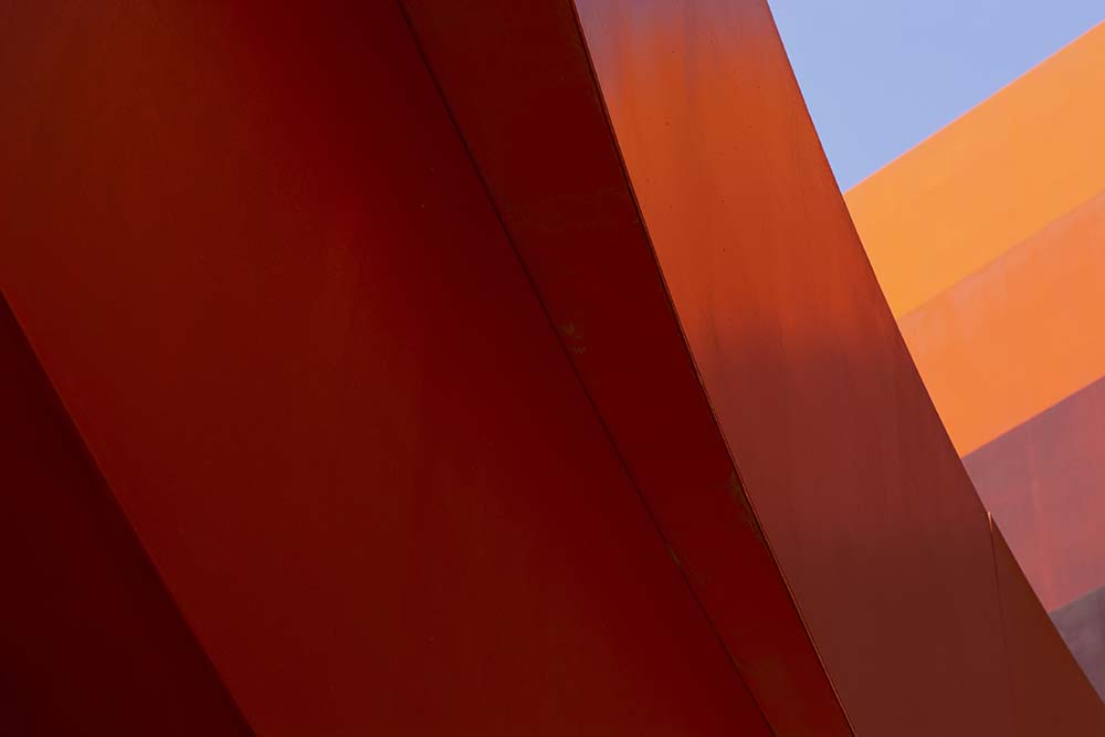 Flow I by Tal Paz-Fridman — fine-art photograph of converging lines in blue, red and orange tones