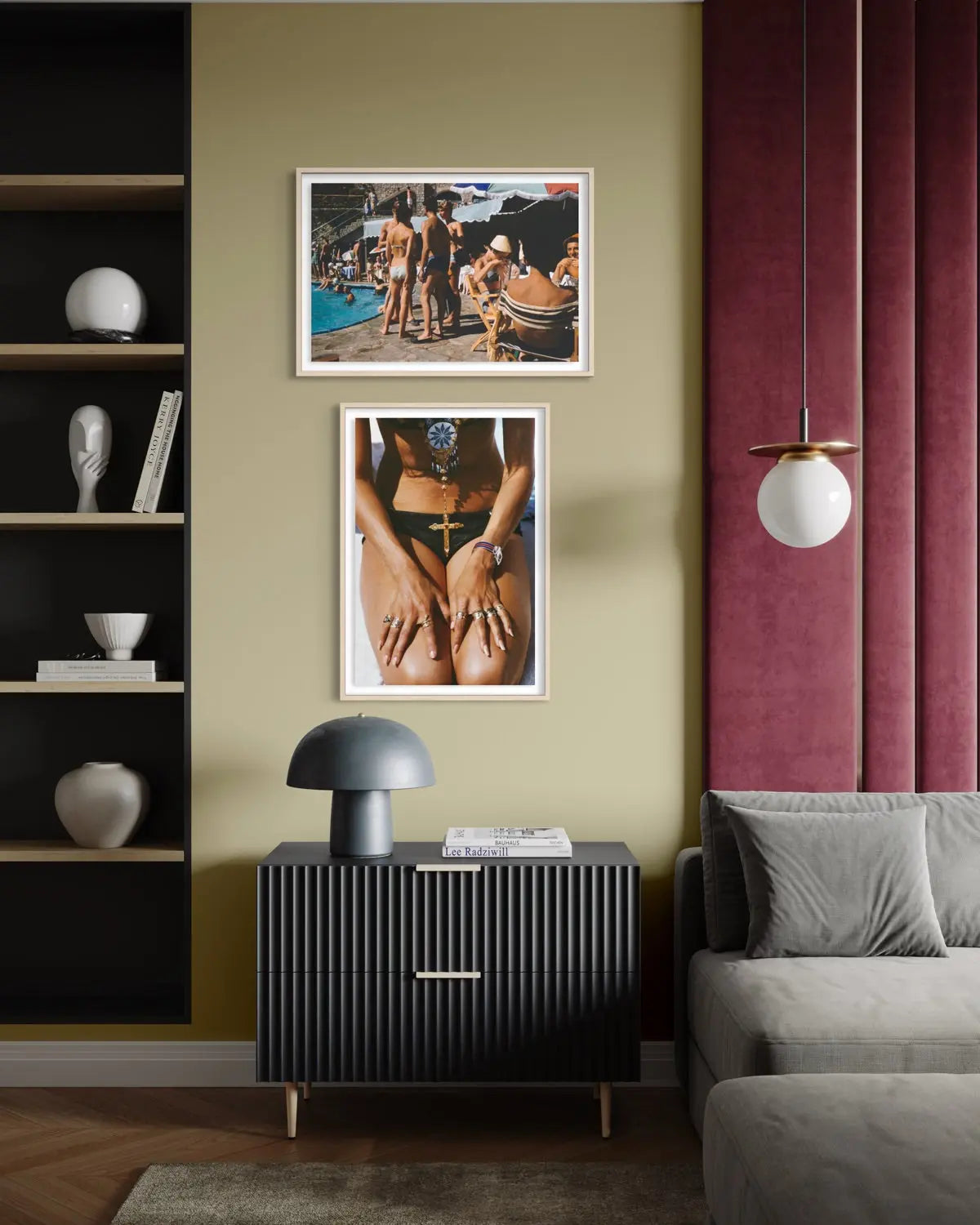 A styled interior room showing two framed art prints hanging on a beige wall above a dark ribbed cabinet. The prints feature swimwear imagery, with one showing a woman by a pool and the other a close-up of a woman in a green bikini.