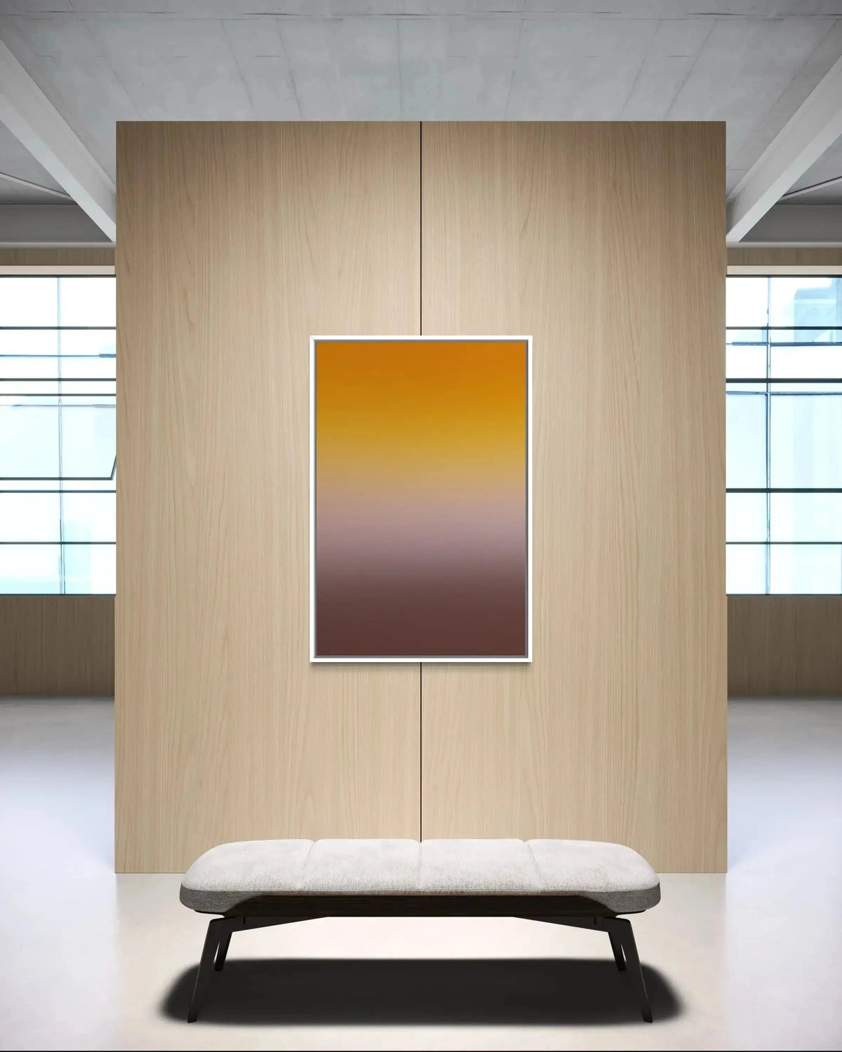 A vertical framed art print featuring a smooth yellow-to-brown gradient, displayed on a light wood panel wall above a modern white bench in a minimalist interior setting.