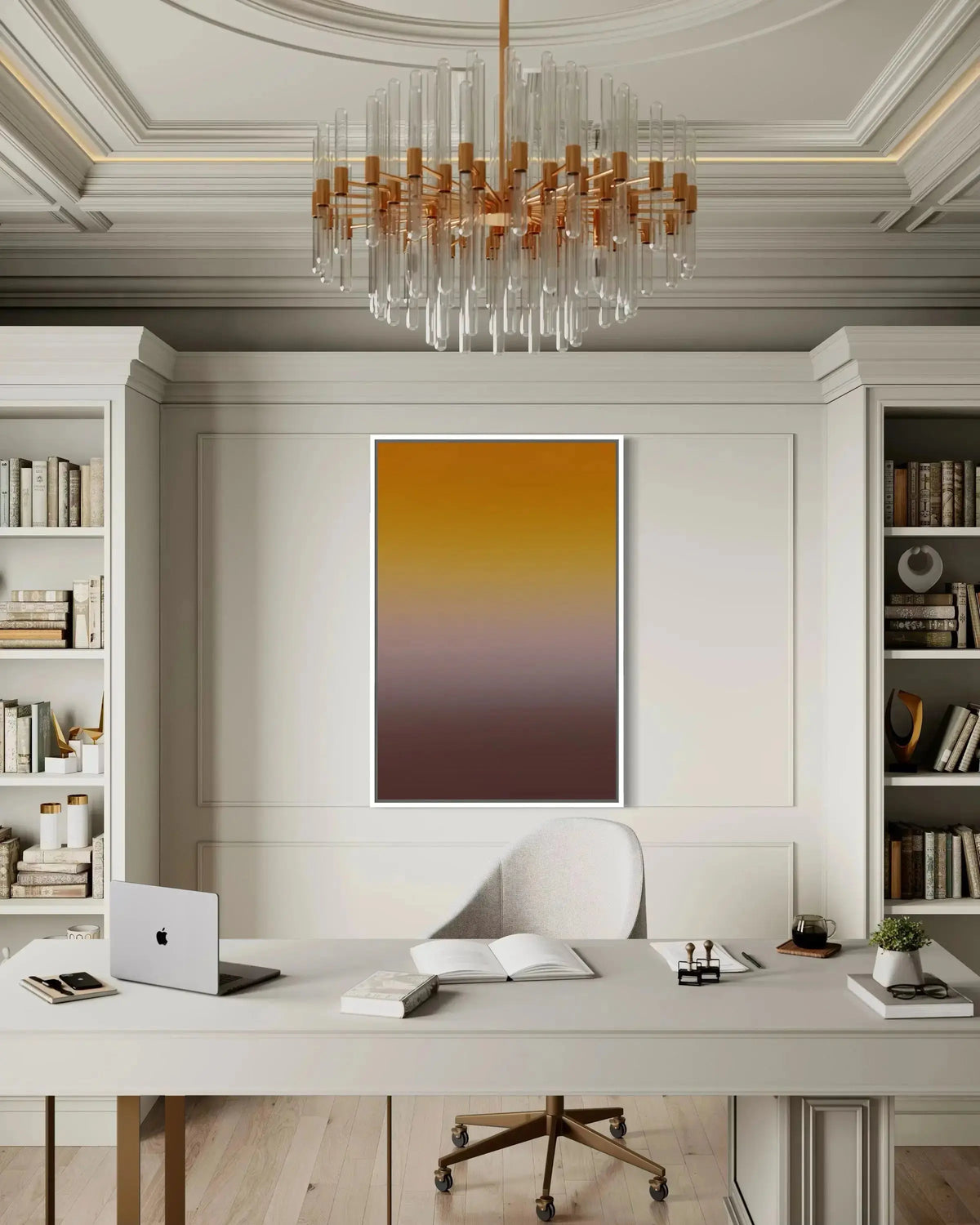 A vertical abstract art print featuring a warm yellow-to-brown gradient, displayed on a white wall in a modern, elegant home office setting with a desk, chair, and chandelier.