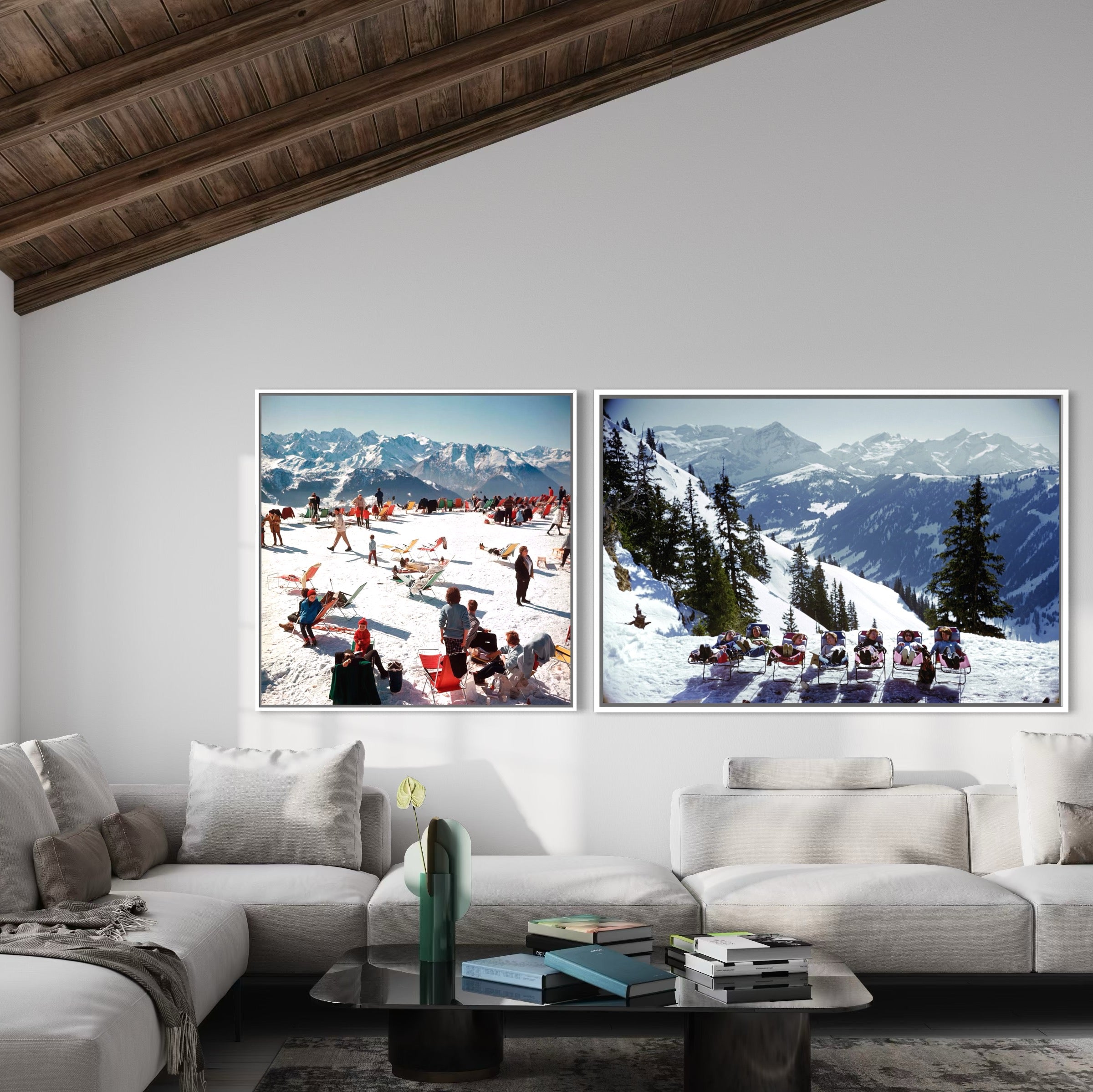 Two framed pictures of snowy mountain landscapes above a white sofa in a living room.