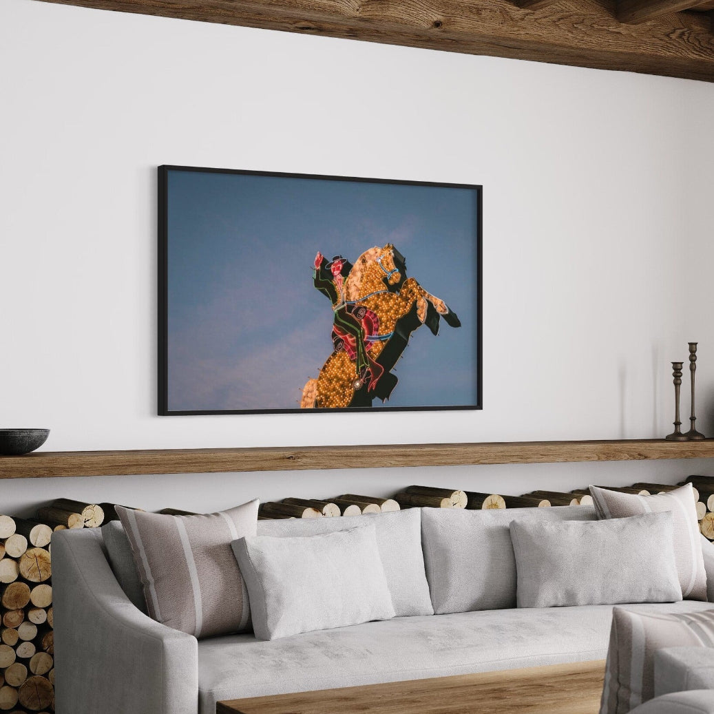 Luminous Cowboy Tale neon cowboy print displayed in a modern living room, designer wall art by The Picturalist.