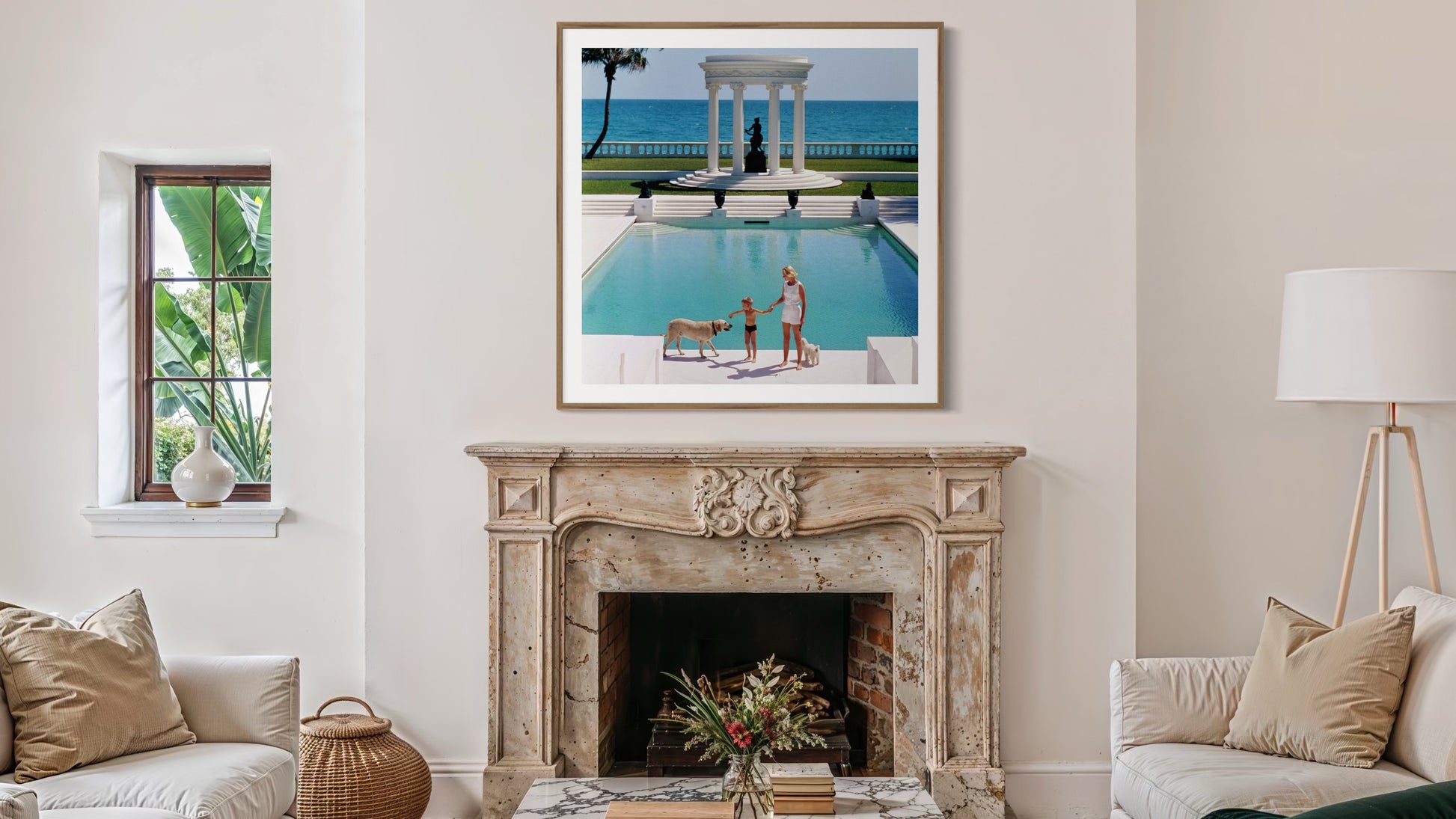Living room with a fireplace, framed picture of a pool scene, and decorative items.