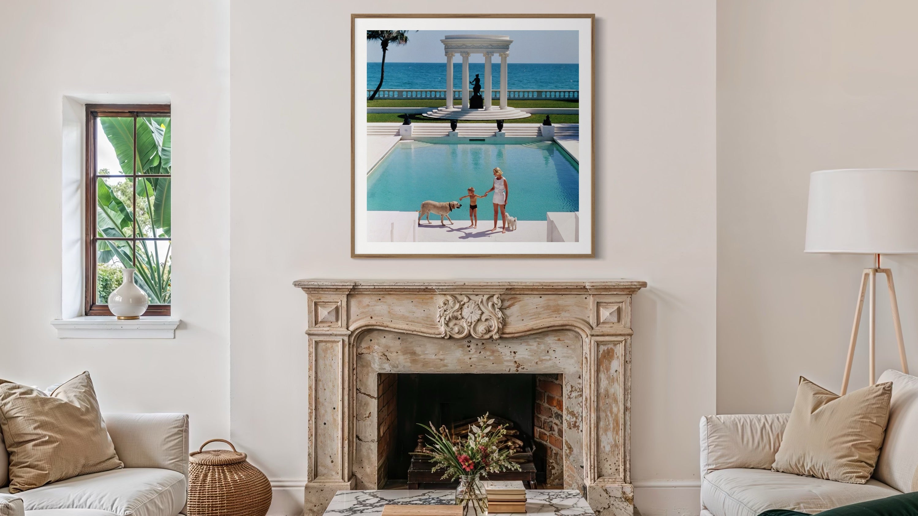 Living room with a fireplace, framed picture of a pool scene, and decorative items.