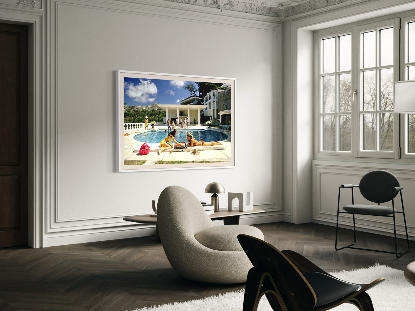 Living room with a large framed picture of a pool scene on the wall.