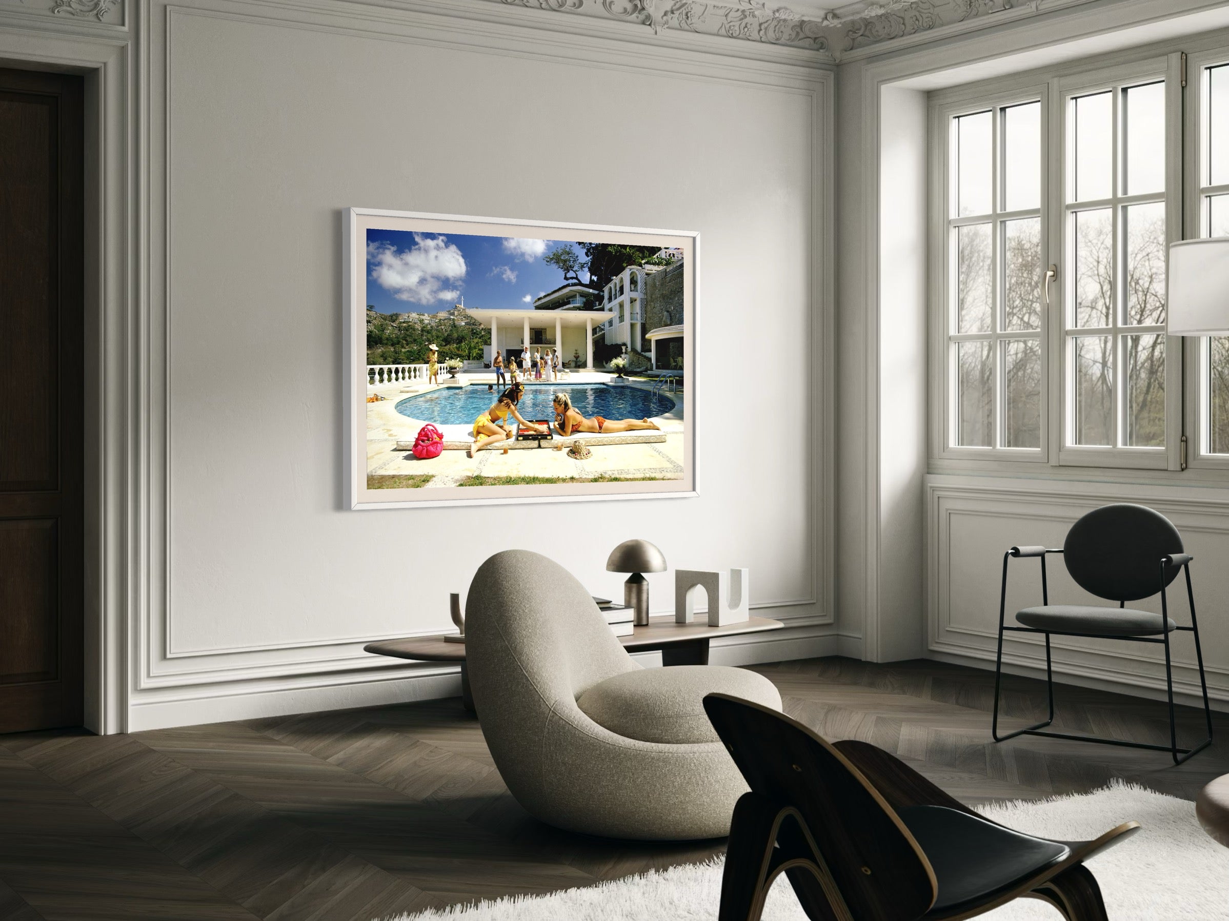 Living room with a large framed picture of a pool scene on the wall.