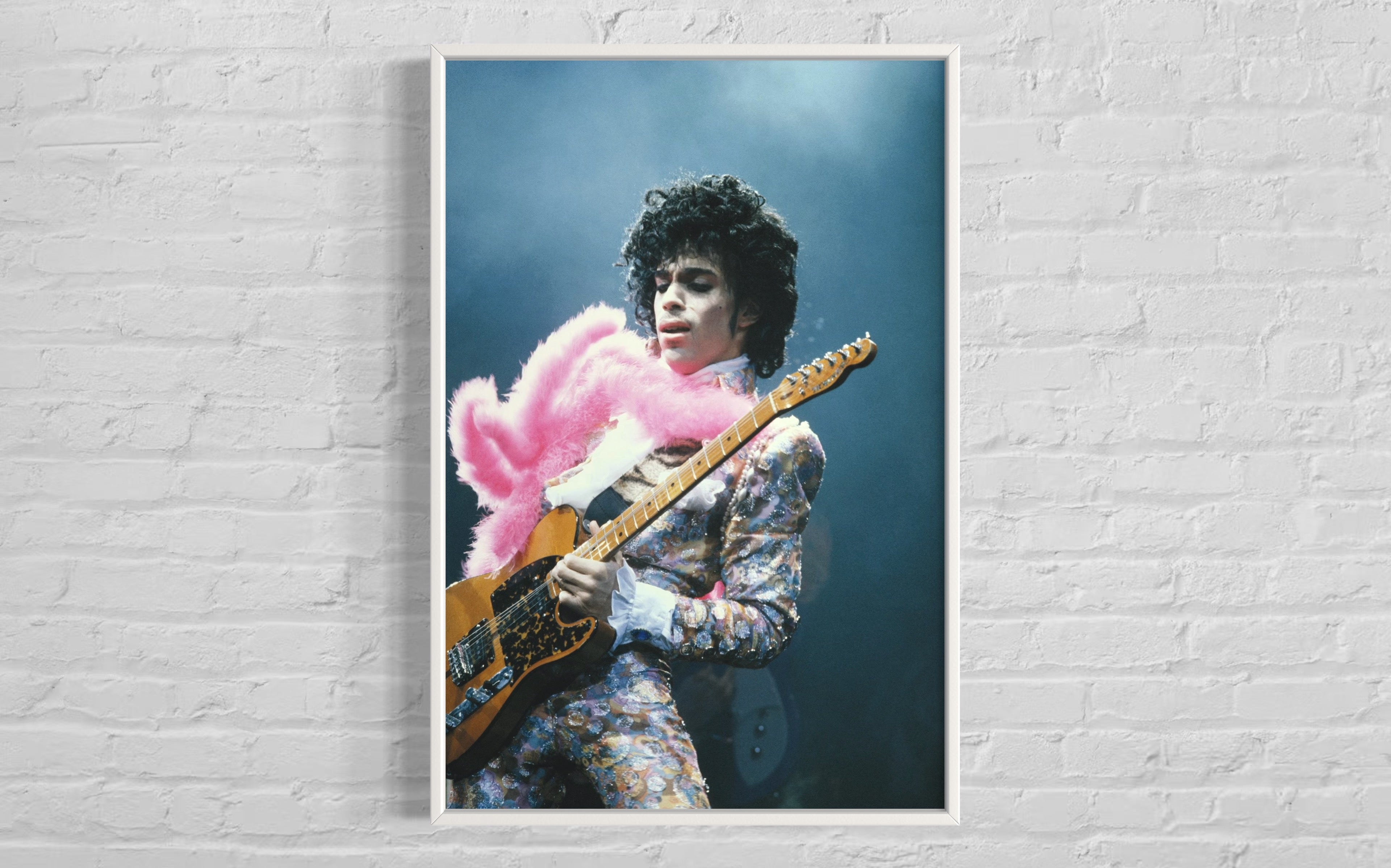 Prince Live at The Forum by Michael Ochs Archives, vibrant concert photograph of Prince performing in pink feathers and sequins, fine art print framed by The Picturalist