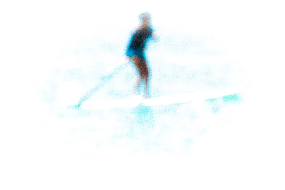 Person water surfing on a blurred background