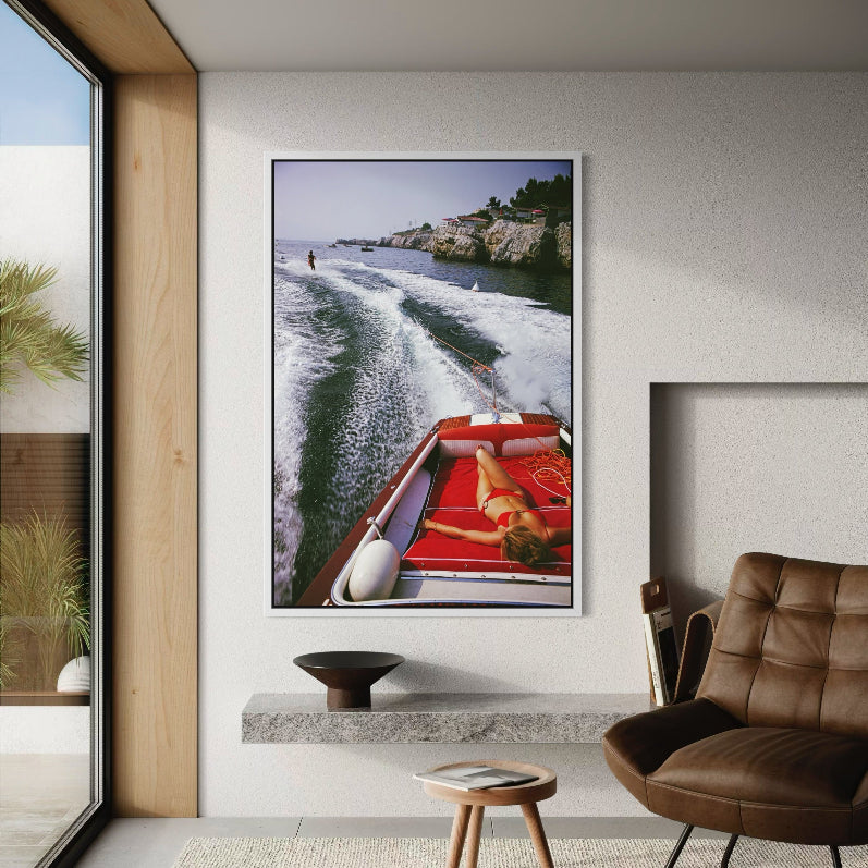 Leisure in Antibes by Slim Aarons shown above a contemporary bed setting, metal print curated by The Picturalist for serene Mediterranean-inspired interiors.