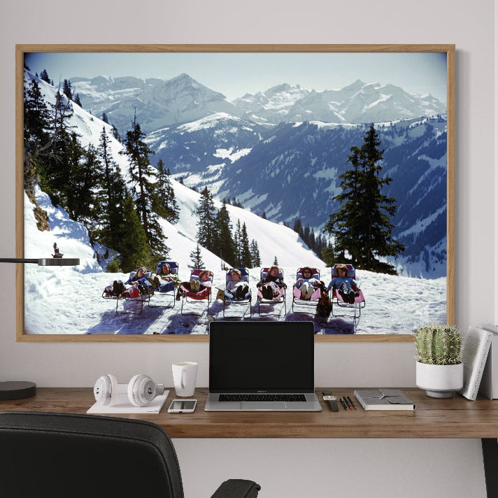 Lounging in Gstaad by Slim Aarons, alpine winter scene with skiers relaxing, premium Chromaluxe metal print licensed through Getty Images and custom framed by The Picturalist.