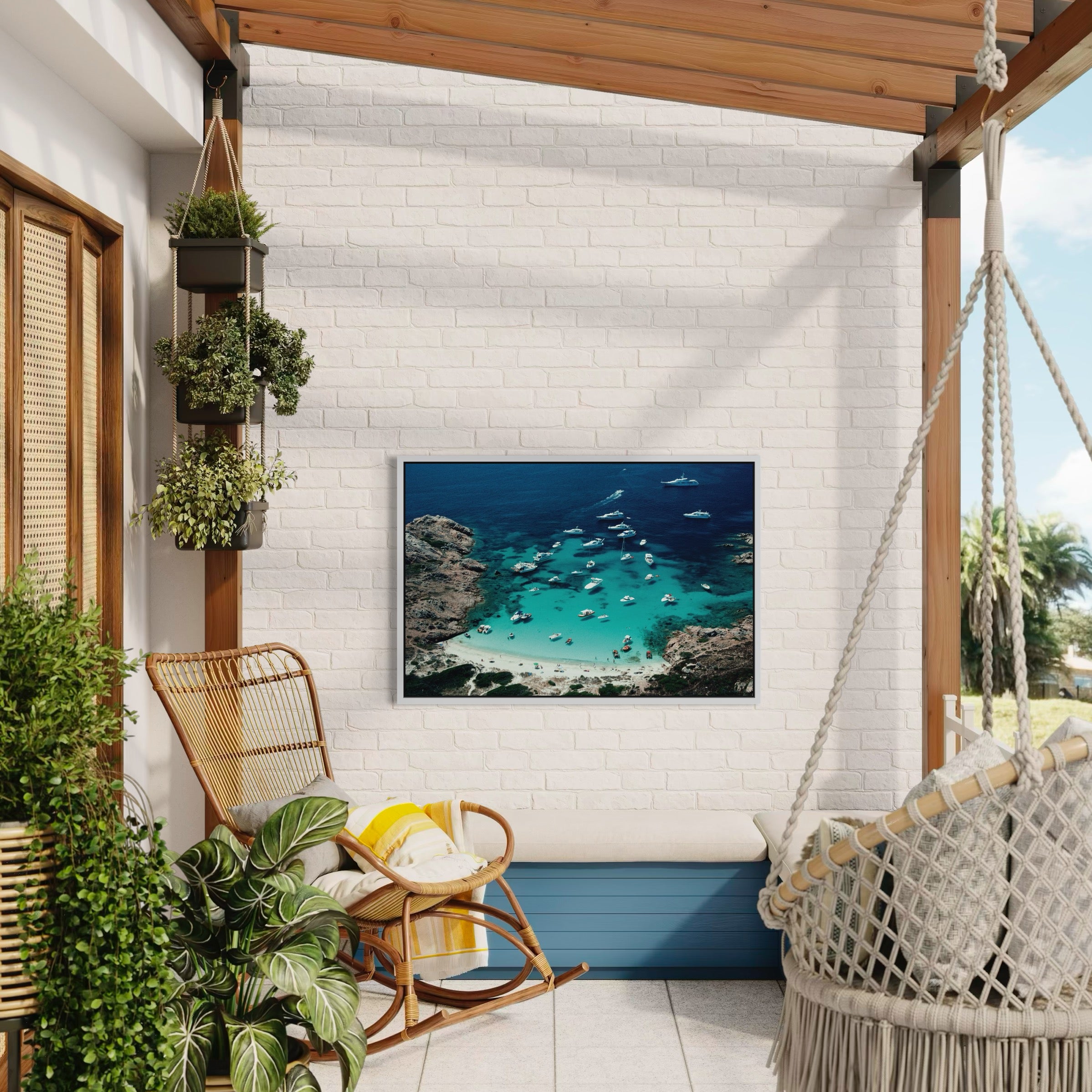 Cozy outdoor patio with a hammock, chair, and framed beach picture on a white brick wall. Porto Rotondo by Slim Aarons displayed in a veranda in a hospitality space, Chromaluxe metal print styled for boutique hotels and refined restaurant interiors by The Picturalist.