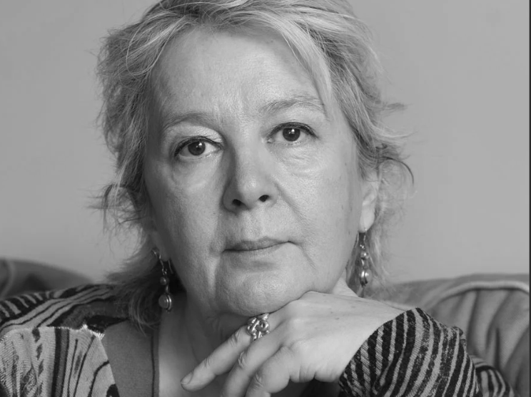 Black and white portrait of a woman with a neutral expression.