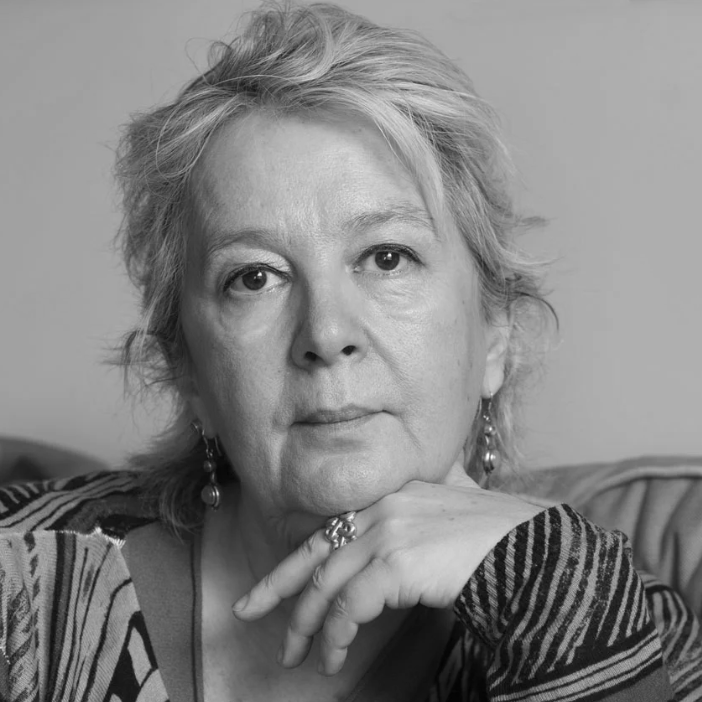 Black and white portrait of a woman with a neutral expression.