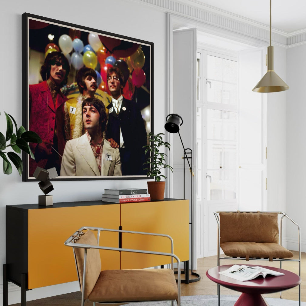 Modern living room with a yellow cabinet, brown chairs, and a framed picture of The Beatles.