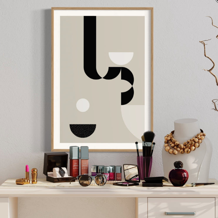Framed abstract art on a desk with makeup and decor items