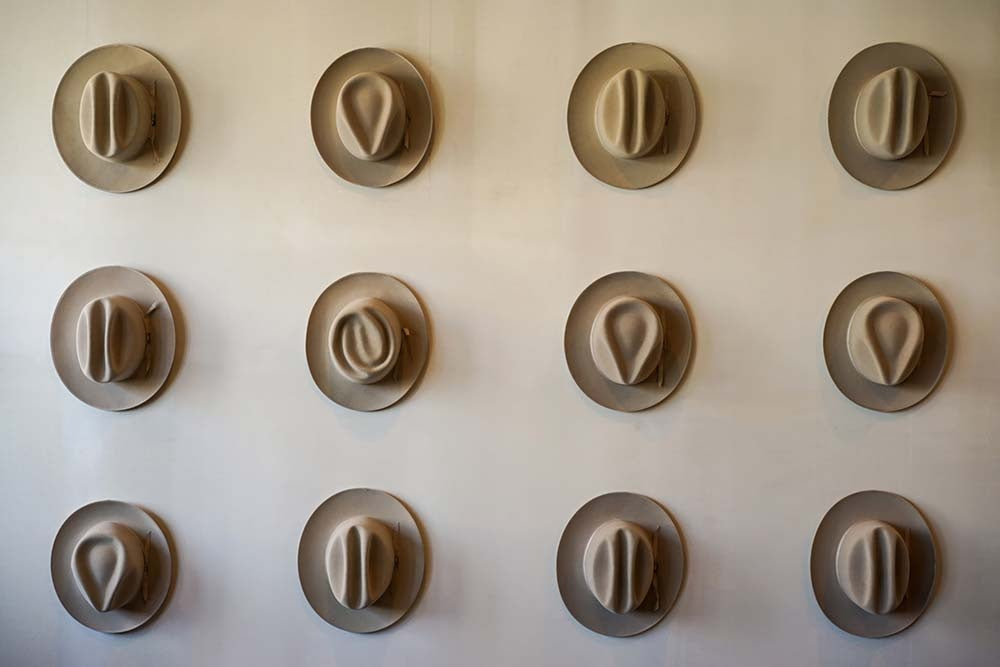 Twelve Hats of the Frontier, sculptural cowboy hats arranged in a grid, Modern Americana fine art print custom framed by The Picturalist.