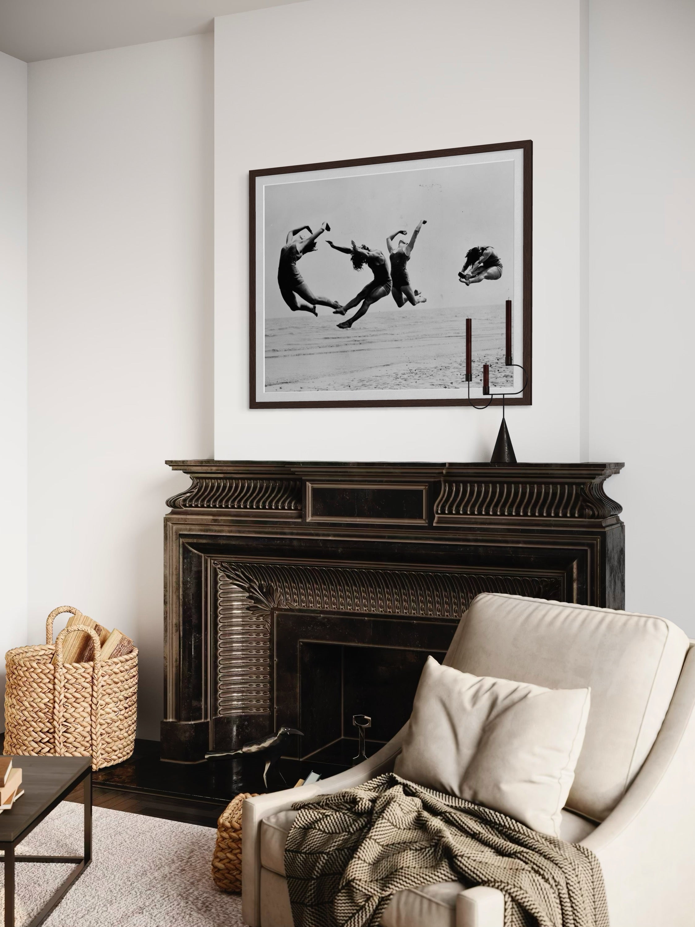 Living room with a fireplace, armchair, and framed black and white artwork.