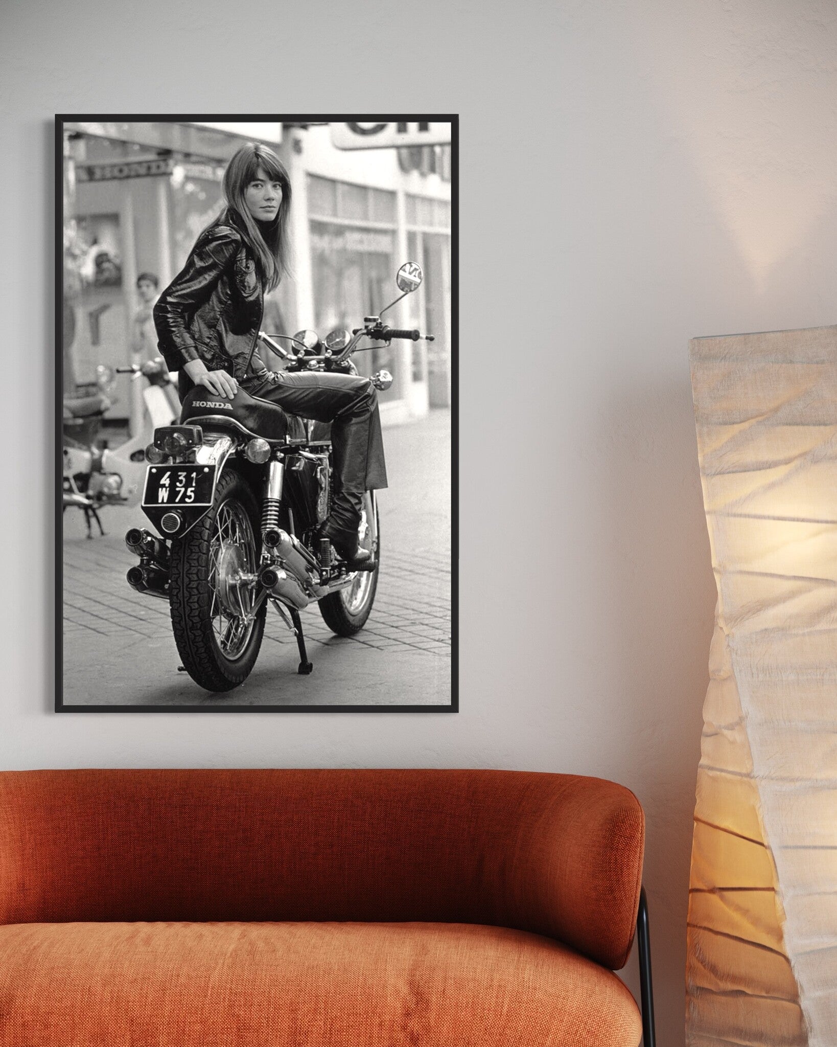 Françoise Hardy seated on a Honda motorcycle, Paris 1960s, photograph by Reg Lancaster, over a sofa