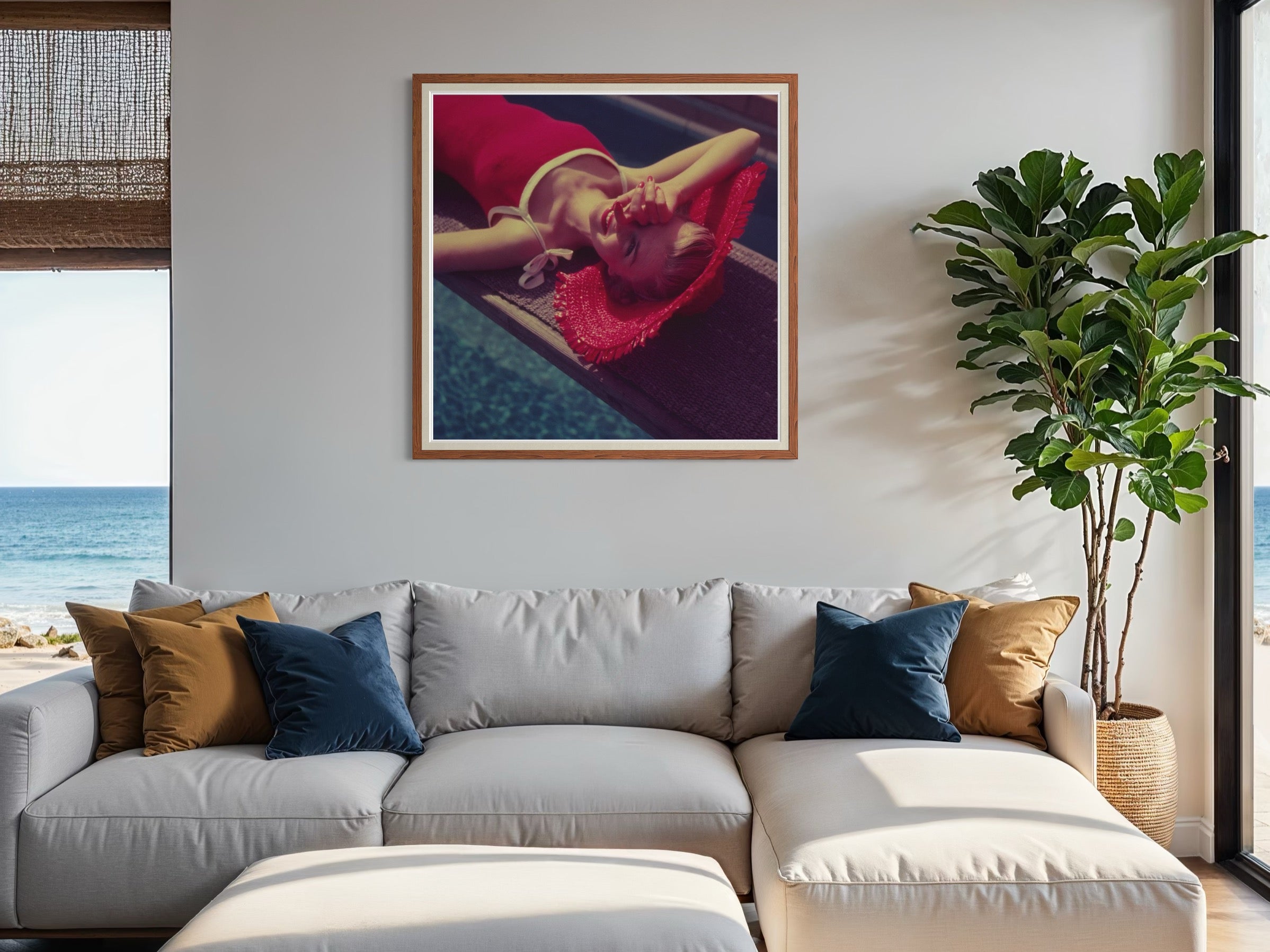 Modern living room with a gray sectional sofa, decorative pillows, and a framed artwork of a woman in a red dress.