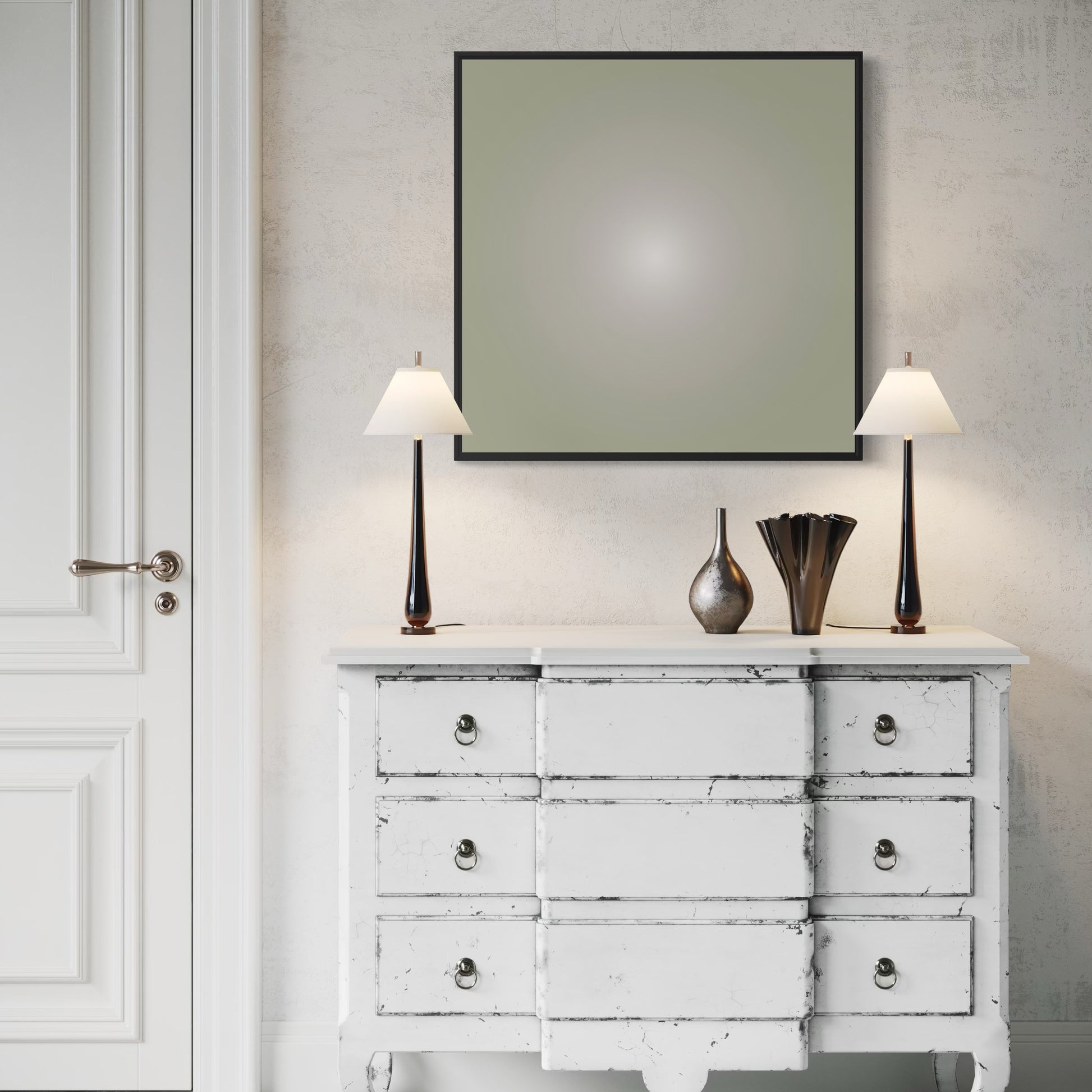 White distressed dresser with two lamps and decorative vases against a neutral wall.