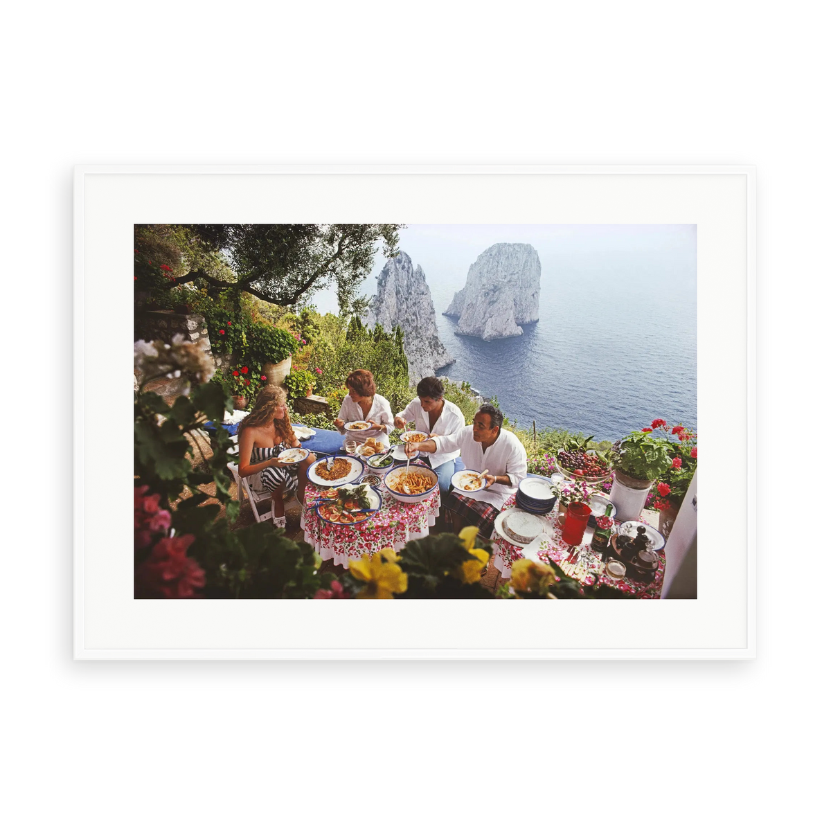 Illustrative matte-white framed preview with white inner border of Dining Al Fresco on Capri by Slim Aarons. Proportions vary by size.