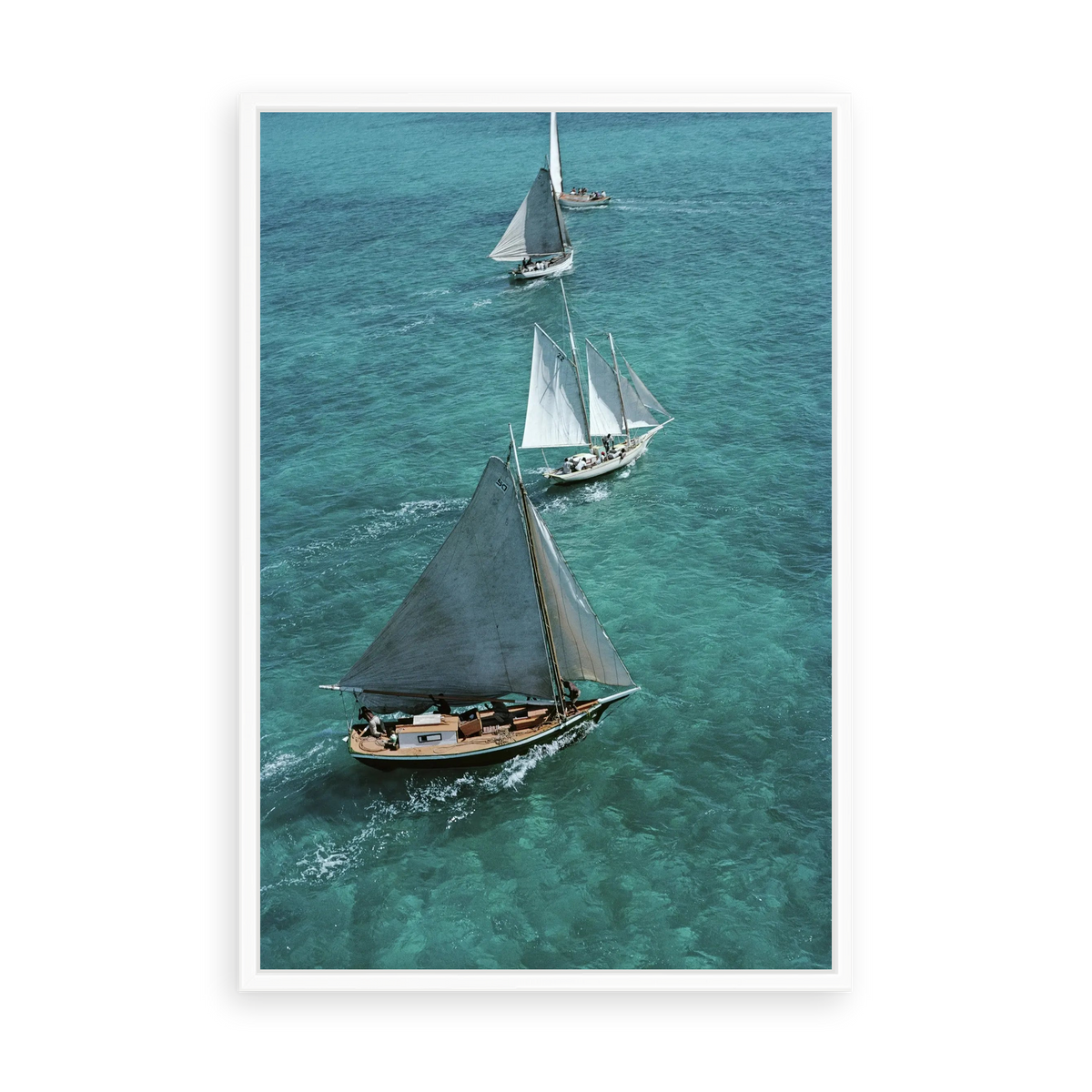 Illustrative matte-white floater-framed preview, without added mat, of Sailing in The Bahamas by Slim Aarons. Proportions vary by size.