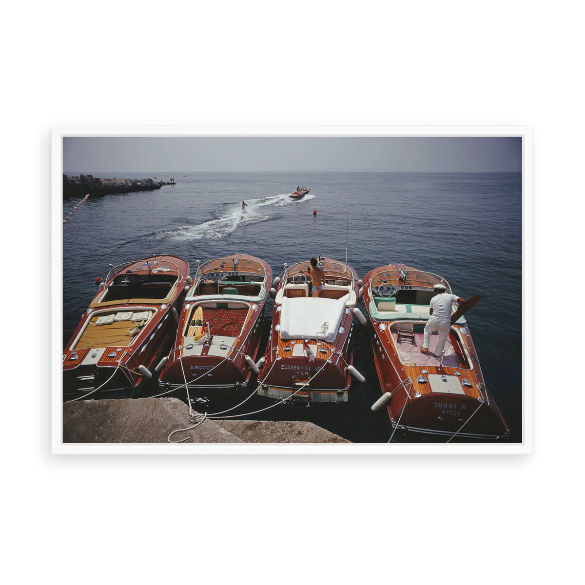 Illustrative matte-white floater-framed preview, without added mat, of Riva Boats at Hôtel du Cap-Eden-Roc by Slim Aarons. Proportions vary by size.