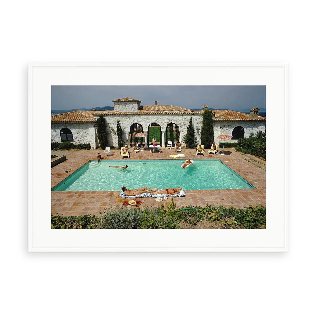 Illustrative matte-white framed preview with white inner border of Pool In St Tropez by Slim Aarons. Proportions vary by size.