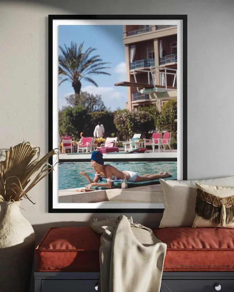 Poolside In Marrakesh Morocco by Slim Aarons displayed in a modern living room interior