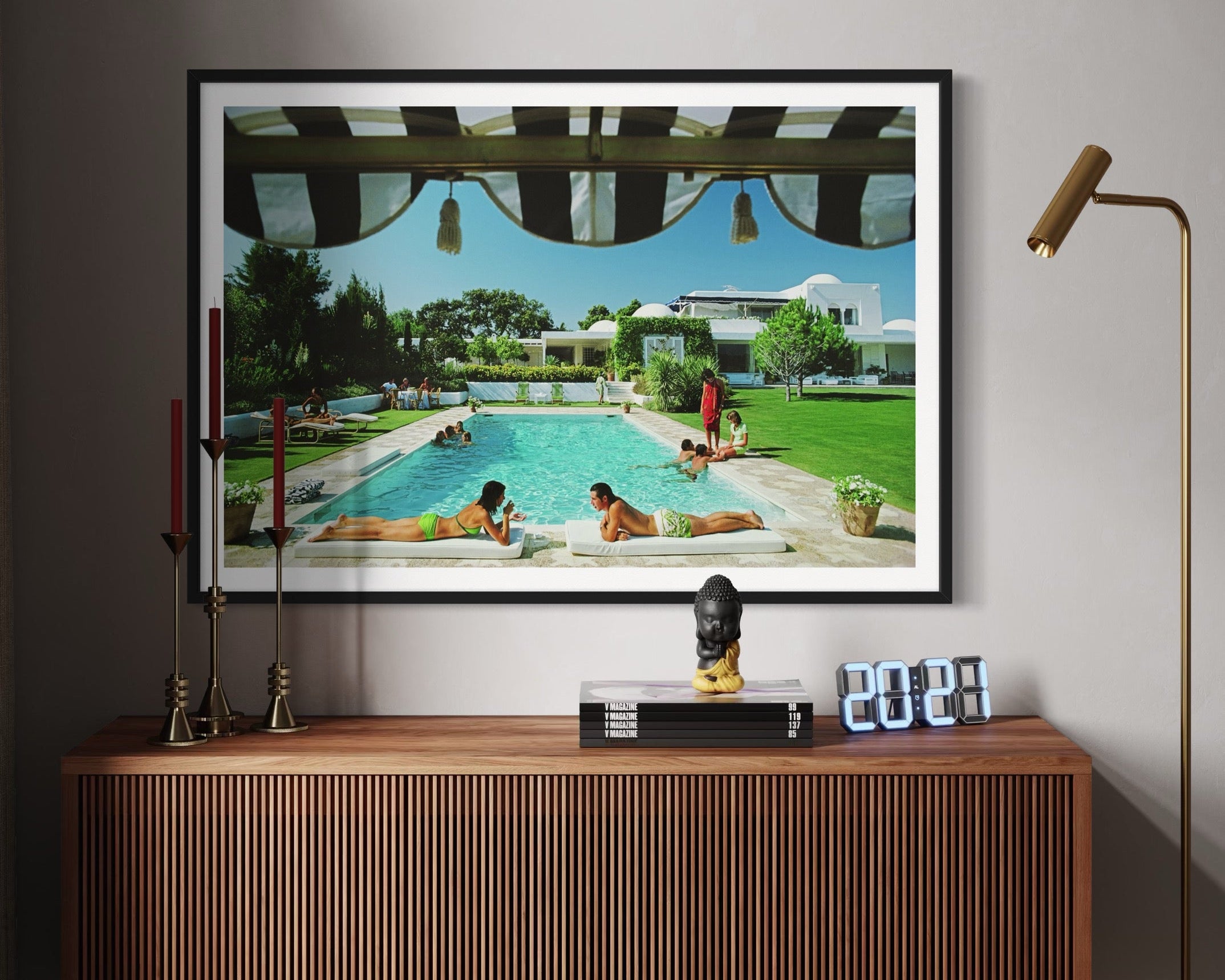 Framed artwork of a pool scene on a wall above a wooden cabinet.