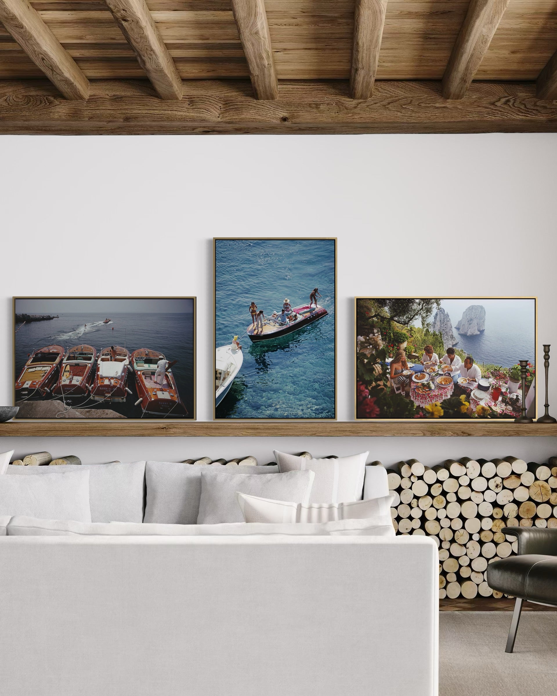Living room with framed photographs of boats and people on a wall.