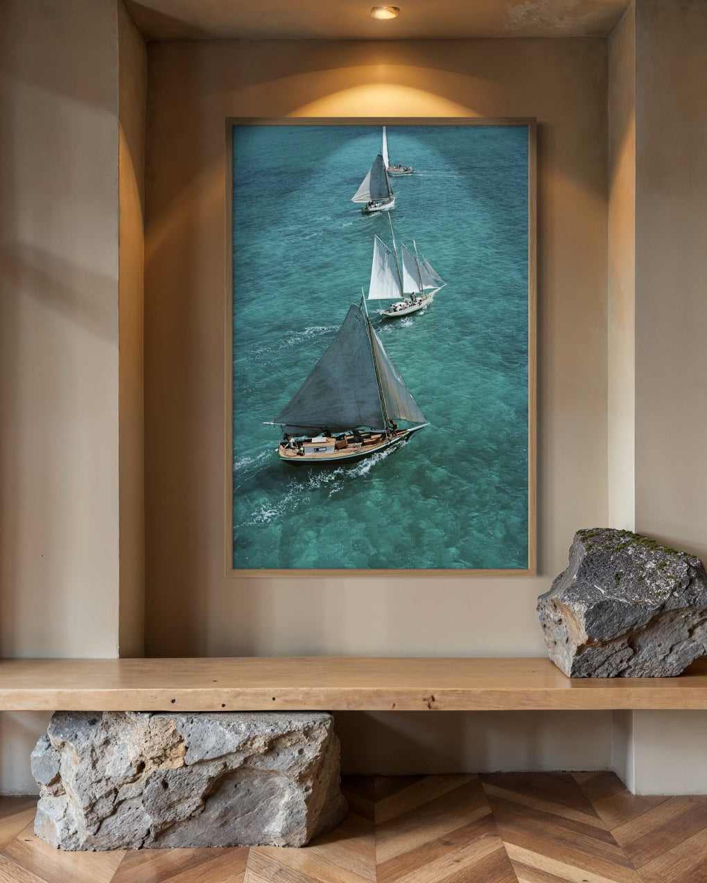 Framed artwork of sailboats on a wall above a wooden shelf.