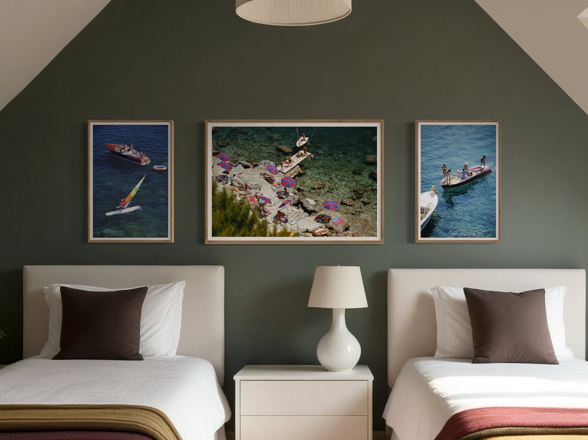 Slim Aarons’ Beach at Il Pellicano above a bed in a serene bedroom, adding exclusive art prints and a refined coastal mood to curated art for hotels and luxury homes.