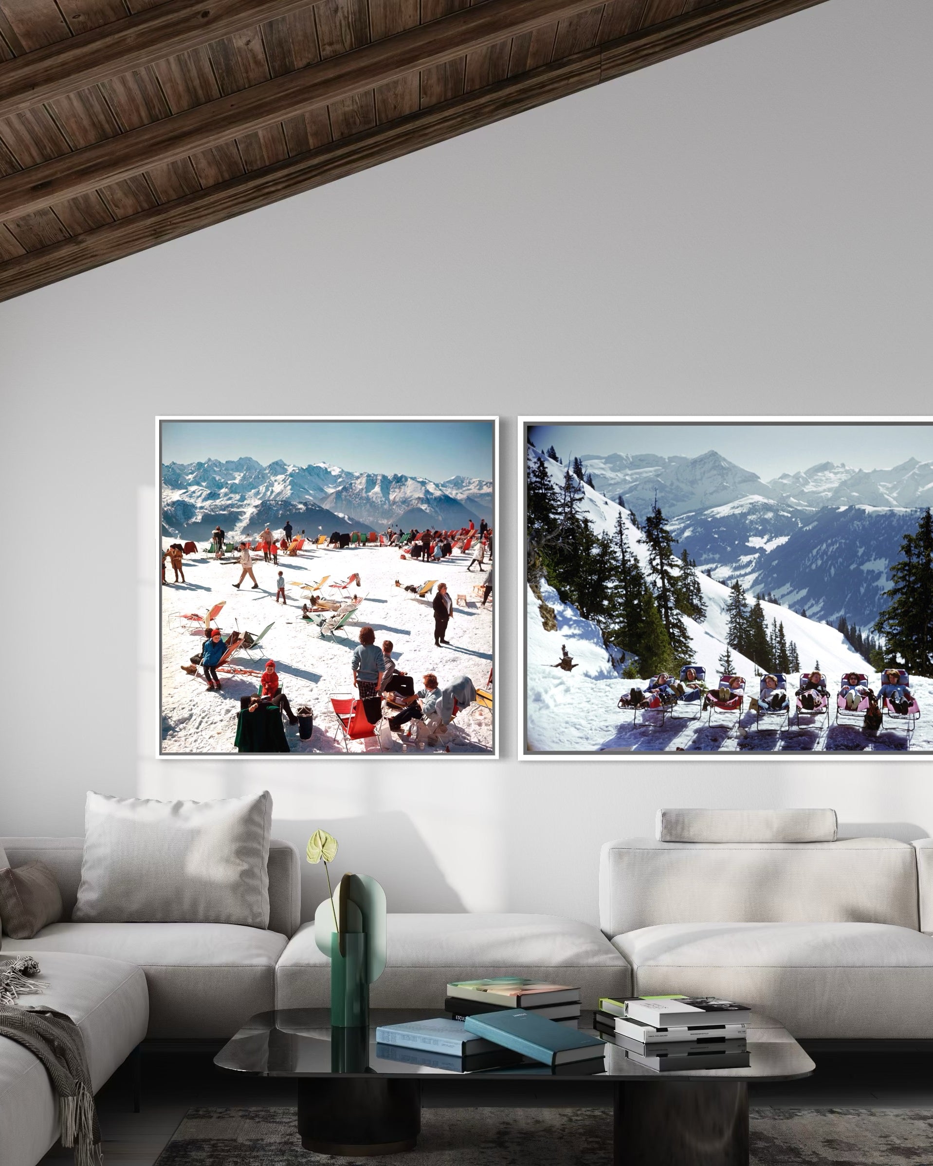 Two framed pictures of snowy mountain landscapes above a white sofa in a living room.