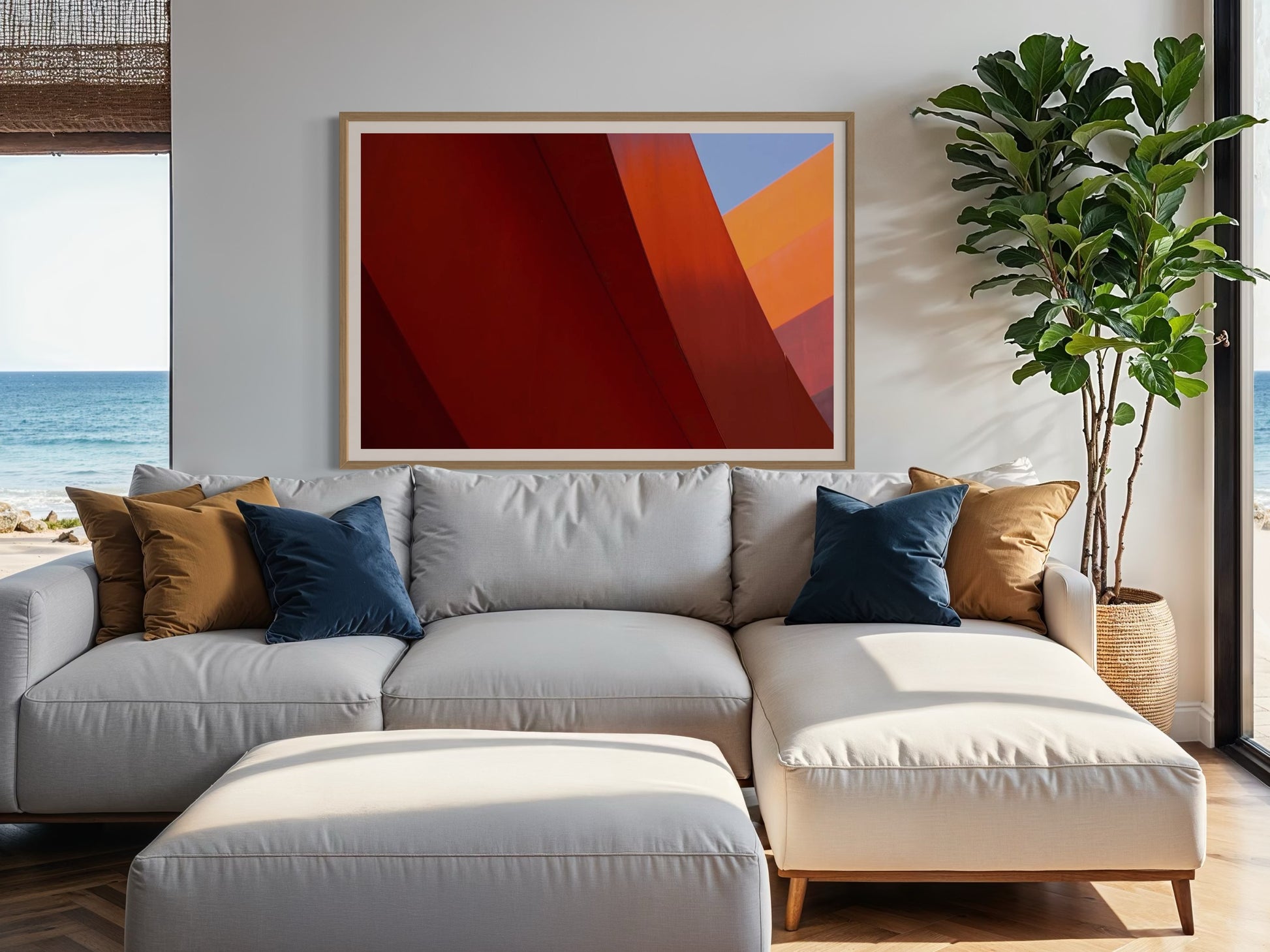 Modern living room with a gray sectional sofa, abstract art, and a plant.