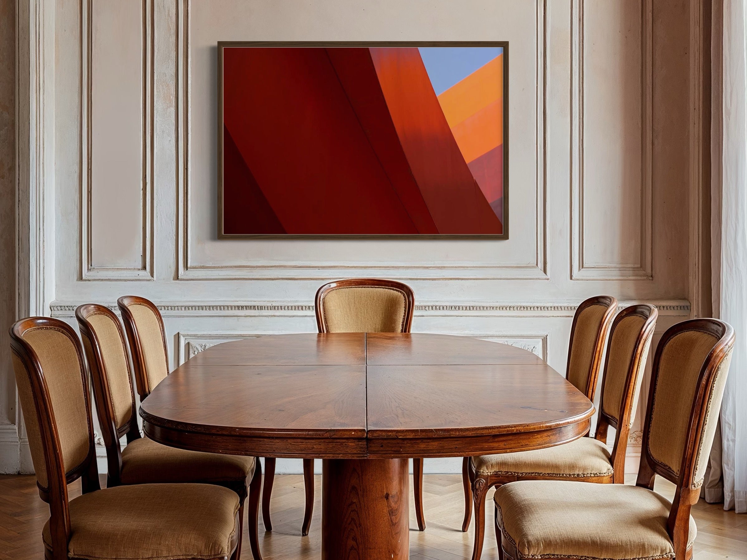 Dining room with wooden table and chairs, abstract art on the wall.