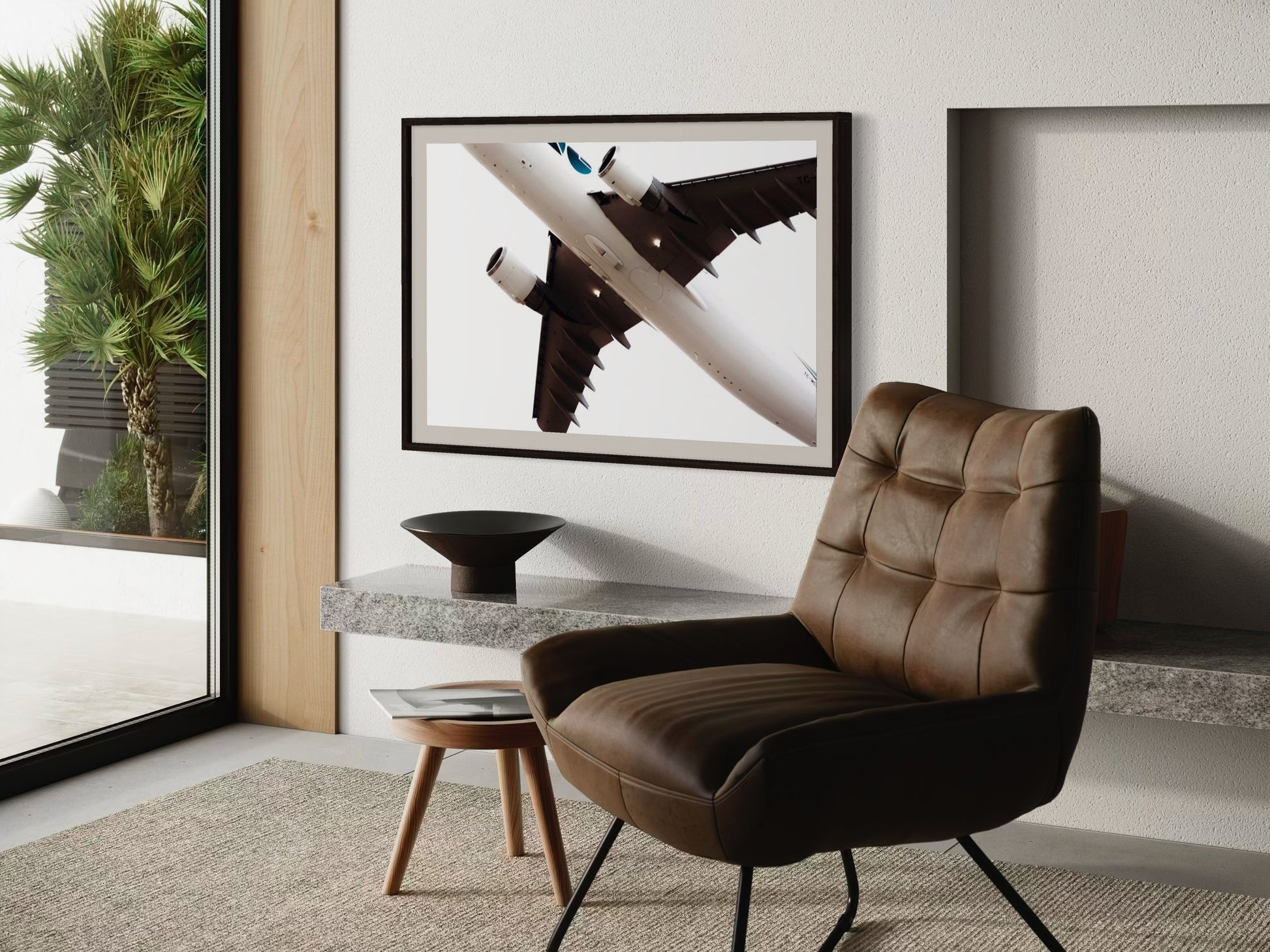 Modern interior with a brown leather chair, side table, and abstract art on the wall.
