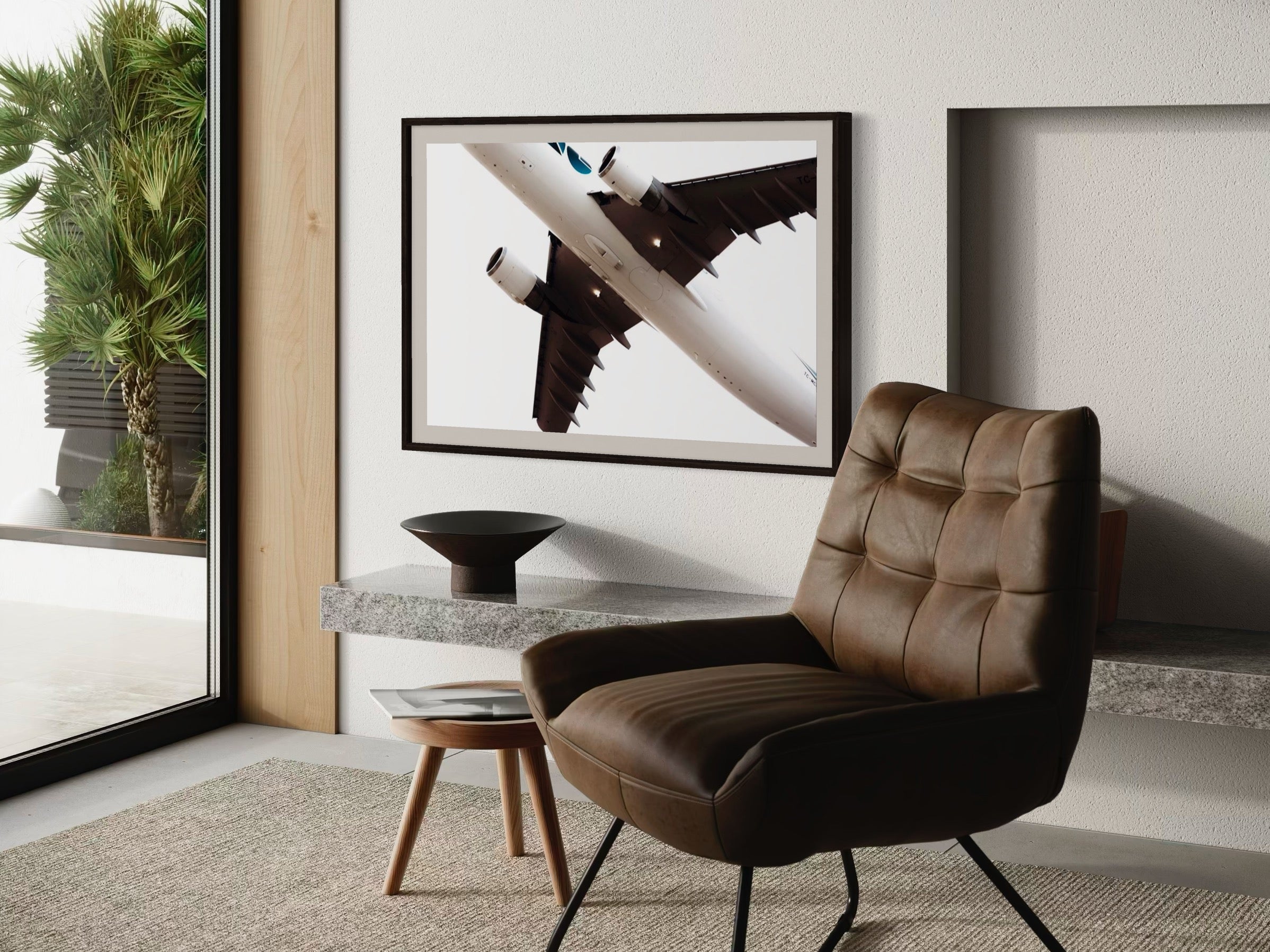 Modern interior with a brown leather chair, side table, and abstract art on the wall.