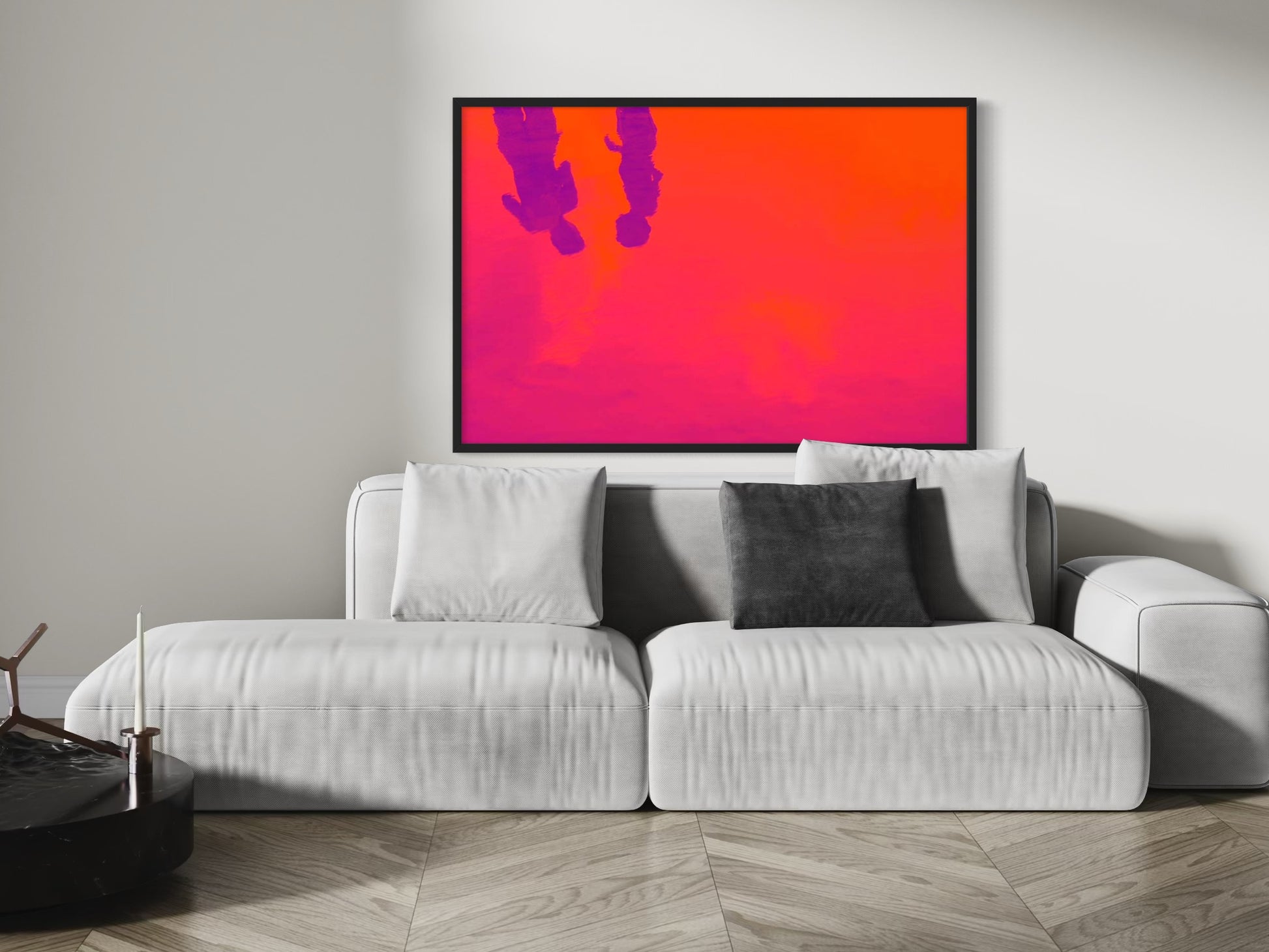 Modern living room with a gray sofa and abstract art on the wall.