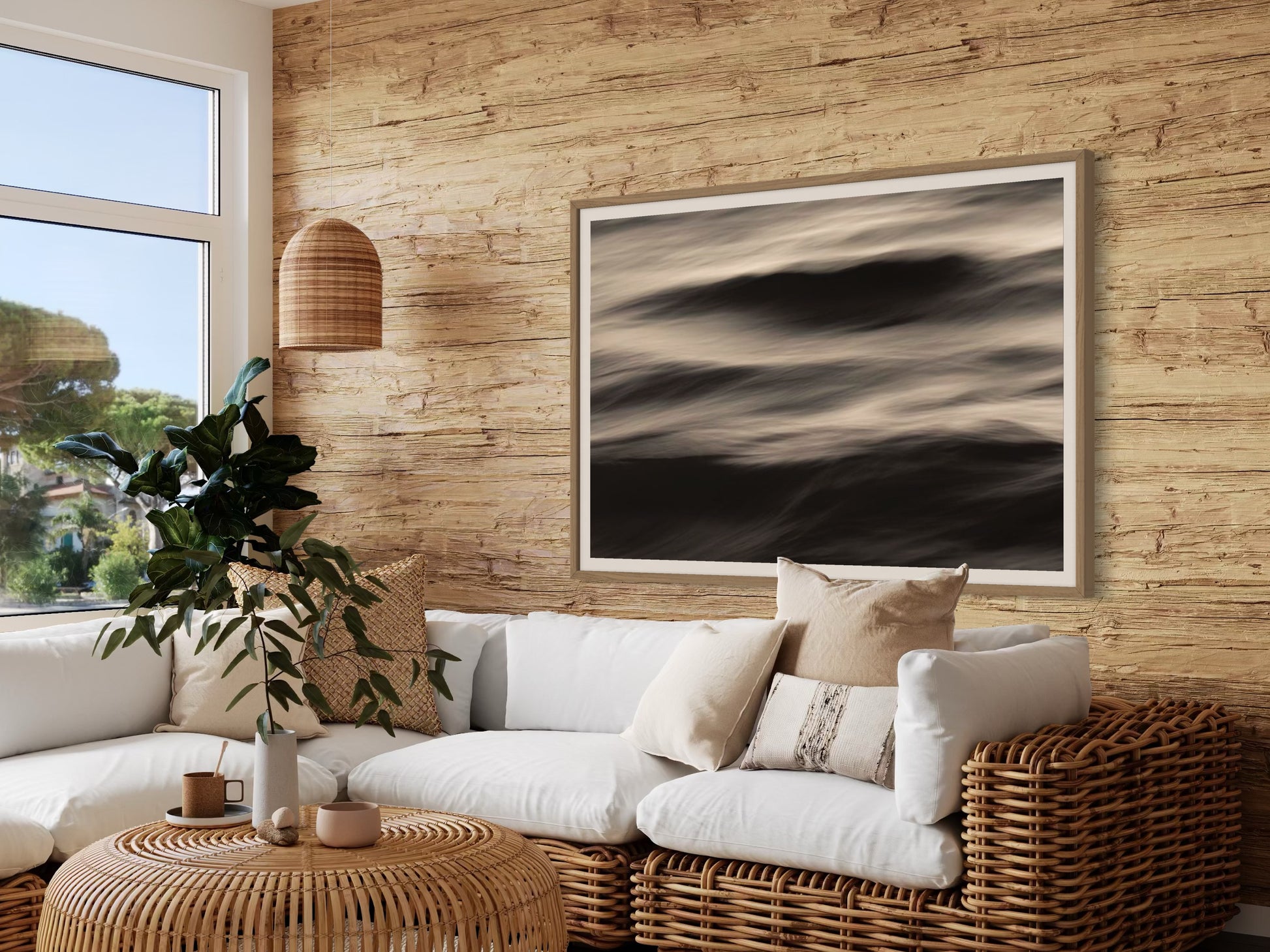 Modern living room with a sectional sofa, wicker chair, and framed abstract art on a wooden wall.