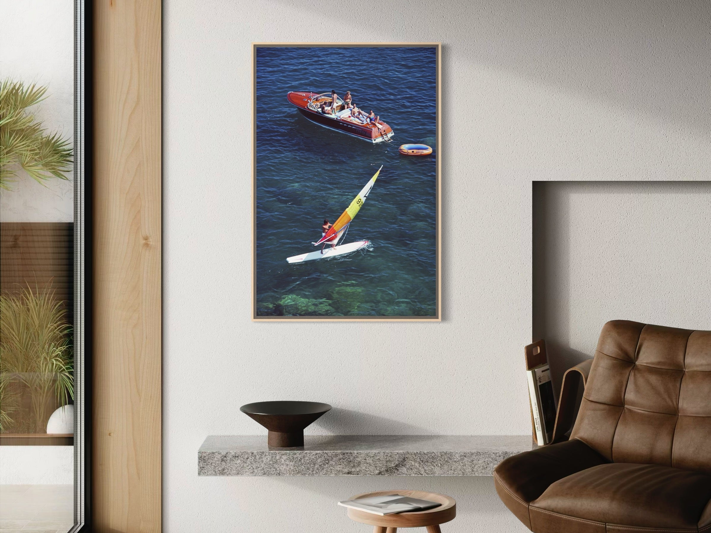 Framed artwork of a boat and sailboat on water in a modern living room.