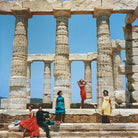 Four women modeling colorful vintage dresses posing in front of the ancient stone columns of the Temple of Poseidon at Santorini, Greece. The Picturalist Wall Art and Photography for Designed Interiors. Slim Aarons Collection, Architecture. Getty Images Gallery. 