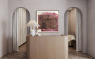 Abstract magenta and neutral canvas by Lidia Beiza styled above dcommercial space counter and soft neutral interior, The Picturalist