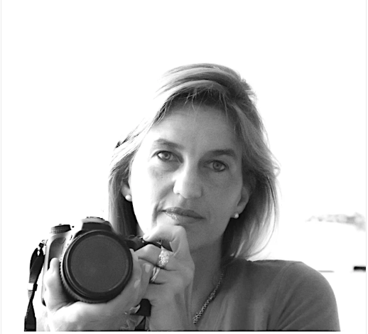 Black and white photo of a woman holding a camera
