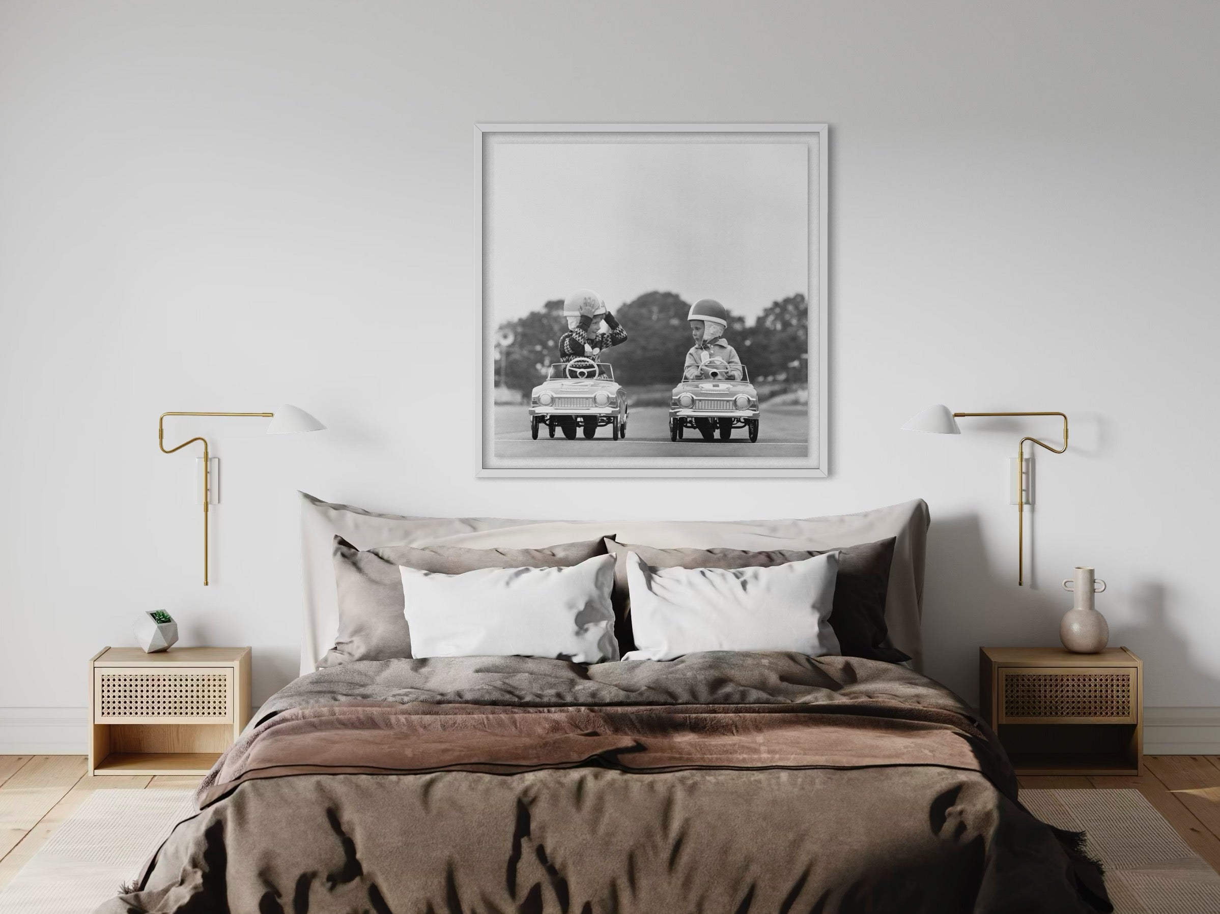 Bedroom with a large bed, nightstands, and a framed black and white photograph on the wall.